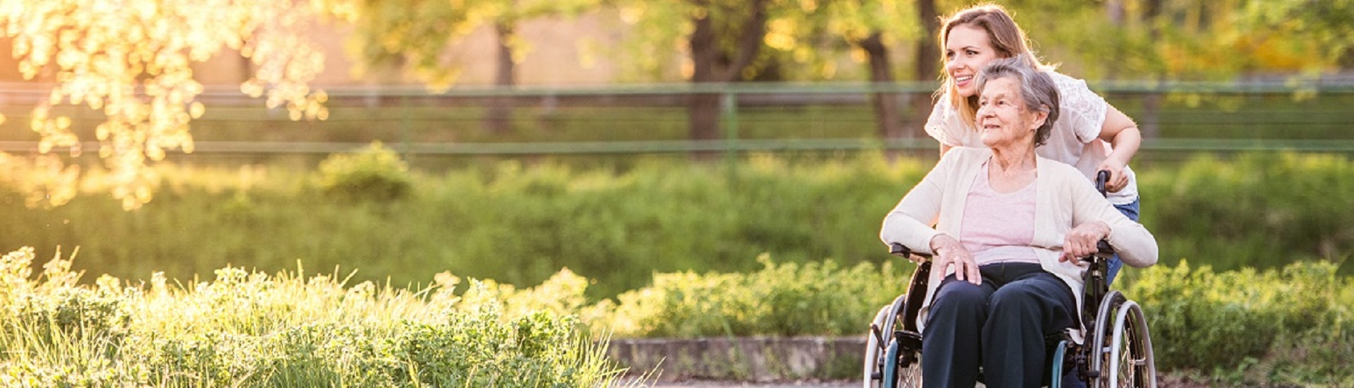 caregiver and elderly woman in a wheelchair